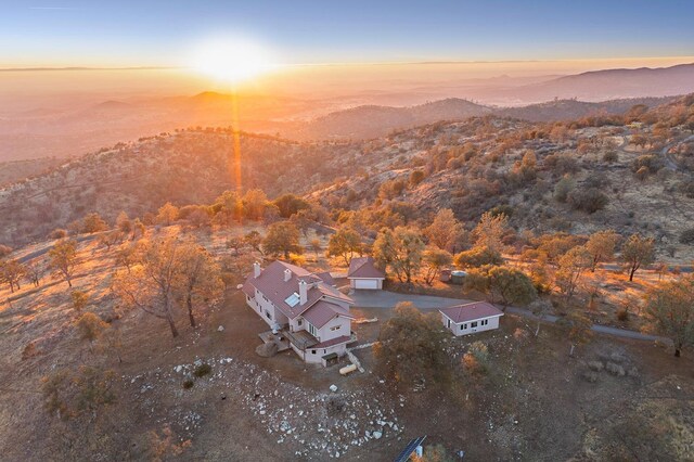 aerial view at dusk featuring a mountain view