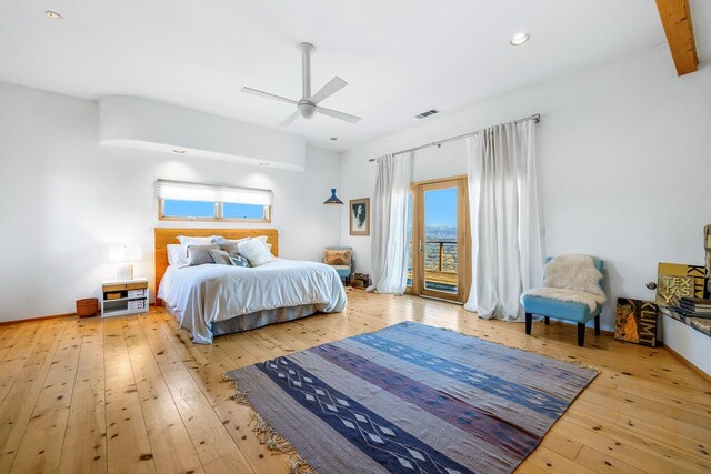 bedroom featuring ceiling fan, light wood-type flooring, access to exterior, and multiple windows