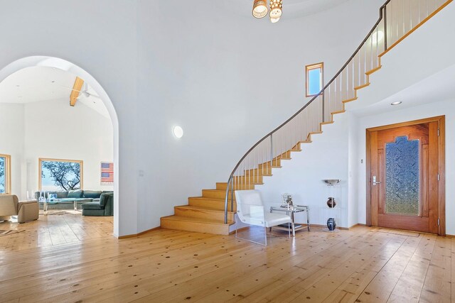 entryway with a high ceiling and light wood-type flooring