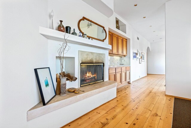 living room with sink and light hardwood / wood-style flooring