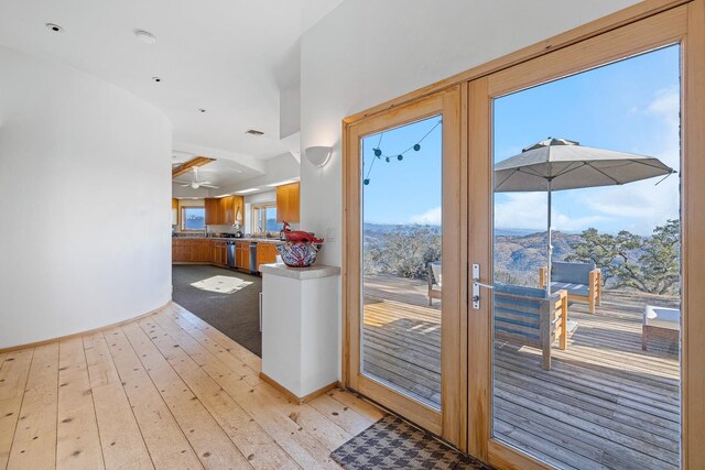 entryway with light hardwood / wood-style flooring and ceiling fan