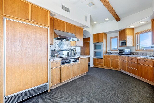 kitchen with beamed ceiling, stainless steel appliances, backsplash, and light stone counters