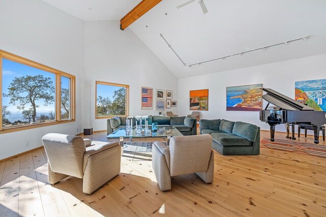 living room featuring beamed ceiling, light hardwood / wood-style flooring, and high vaulted ceiling