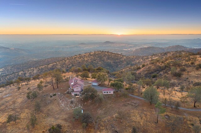 aerial view at dusk featuring a mountain view