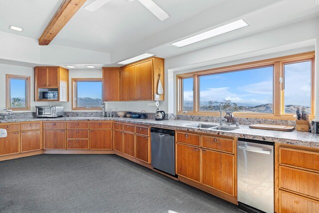 kitchen featuring plenty of natural light, beam ceiling, dishwasher, and sink