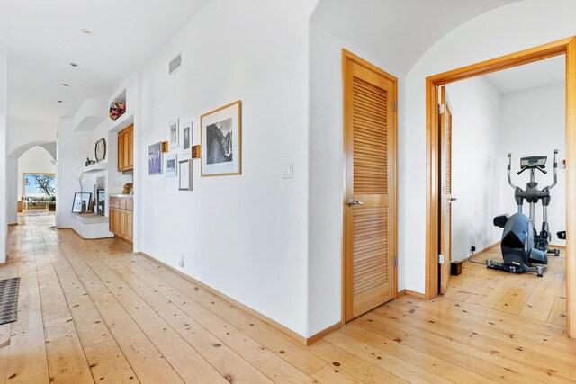 hallway with light hardwood / wood-style flooring