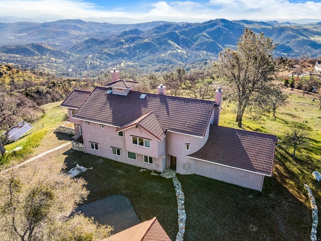 birds eye view of property featuring a mountain view