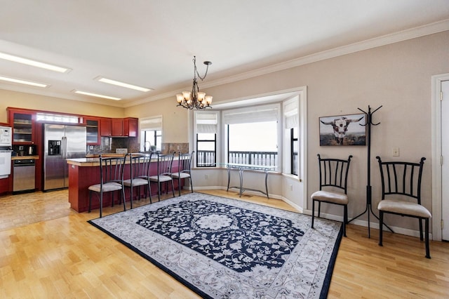 interior space featuring a notable chandelier, crown molding, and light hardwood / wood-style floors