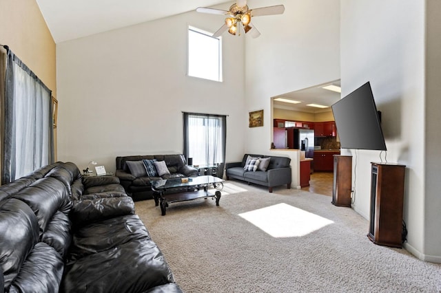 tiled living room with ceiling fan and high vaulted ceiling