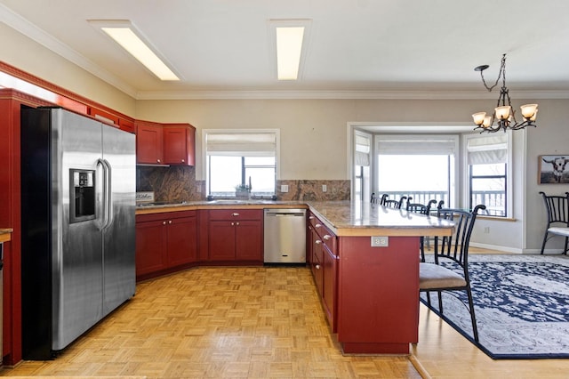 kitchen with stainless steel appliances, a notable chandelier, kitchen peninsula, light parquet flooring, and backsplash