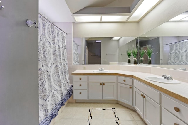 bathroom featuring tile floors and dual vanity