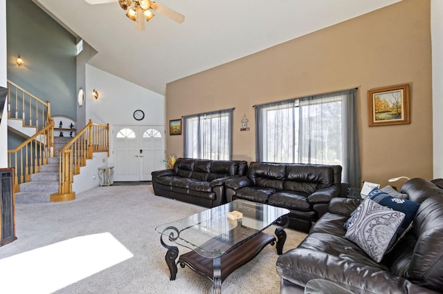 living room with high vaulted ceiling, ceiling fan, and light colored carpet