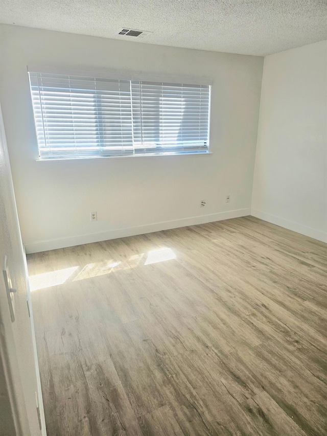 spare room with a textured ceiling