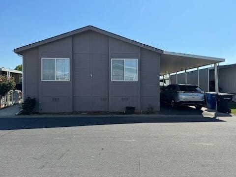 view of property exterior with a carport