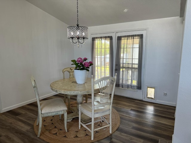 dining room featuring a chandelier and dark wood-type flooring