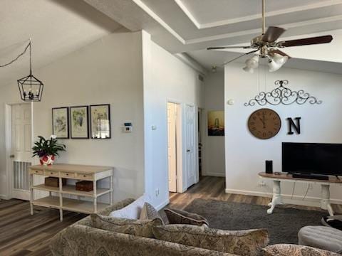 living room featuring lofted ceiling, ceiling fan with notable chandelier, and dark hardwood / wood-style flooring