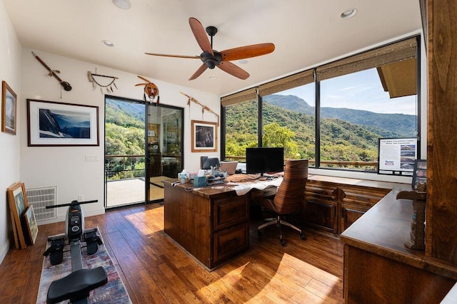 home office featuring hardwood / wood-style floors, a mountain view, ceiling fan, and a wealth of natural light