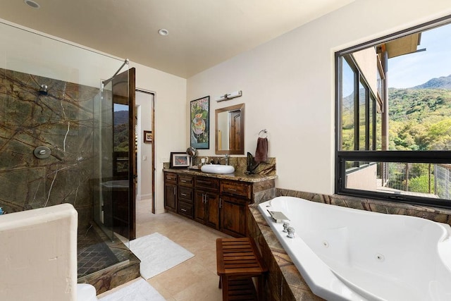 bathroom featuring tile flooring, vanity, and plus walk in shower