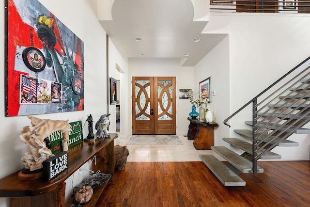 entrance foyer featuring light hardwood / wood-style floors and french doors