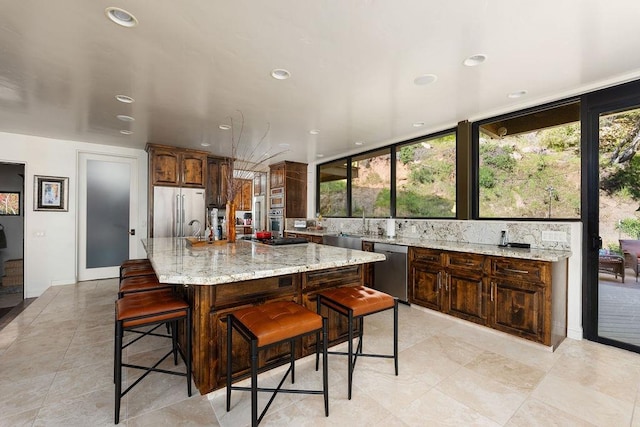 kitchen featuring stainless steel appliances, a center island, and a kitchen bar