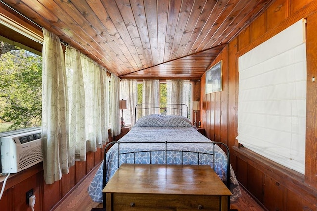 unfurnished bedroom featuring wood walls, vaulted ceiling, dark hardwood / wood-style floors, and wooden ceiling