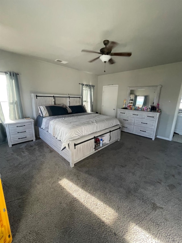 unfurnished bedroom featuring ceiling fan and dark colored carpet