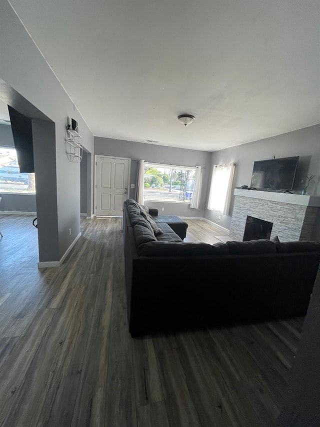 living room featuring a fireplace and dark hardwood / wood-style flooring