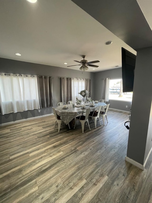 dining room featuring wood-type flooring and ceiling fan