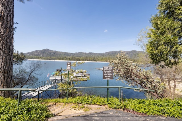 exterior space with a mountain view and a boat dock