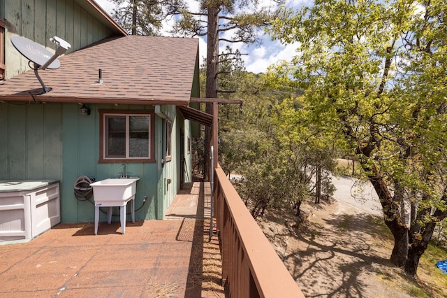 wooden terrace with a patio area