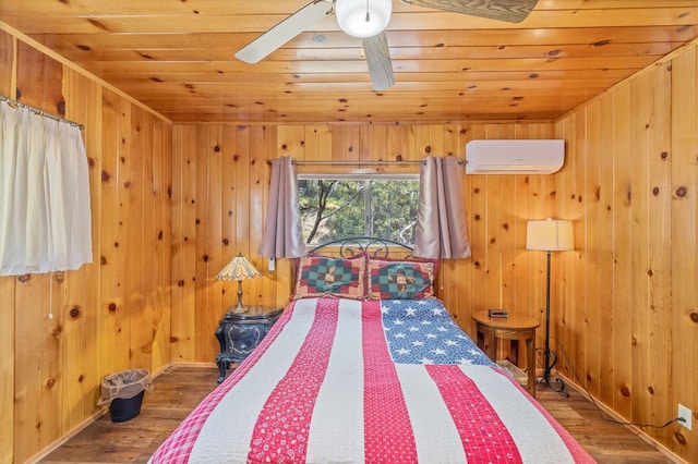 unfurnished bedroom featuring hardwood / wood-style flooring, wood ceiling, ceiling fan, and a wall mounted AC