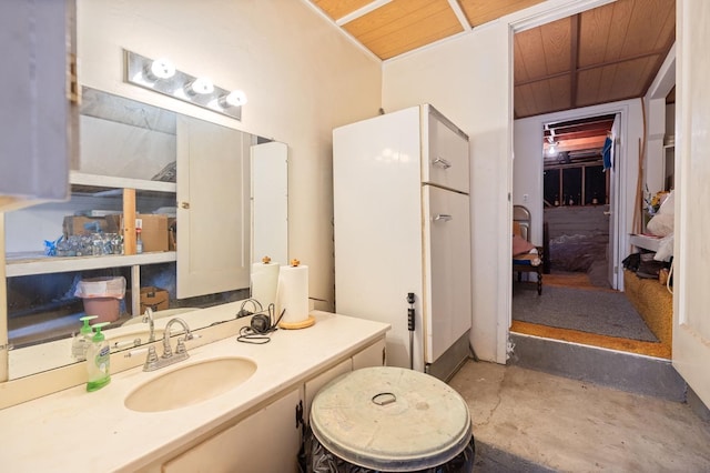 bathroom featuring wood ceiling, concrete floors, and vanity