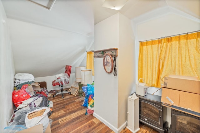 interior space with vaulted ceiling and dark hardwood / wood-style floors