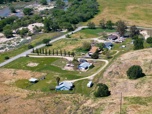birds eye view of property with a rural view