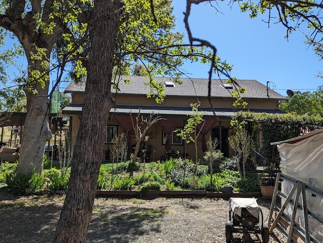 exterior space featuring a shingled roof