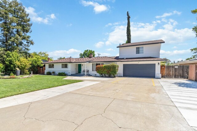 925 S Purdue Ave, Fresno, CA 93727 - traditional-style home with concrete driveway, an attached garage, and stucco siding