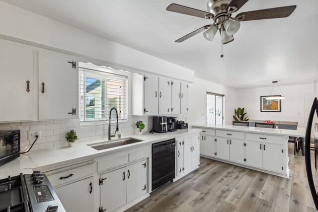 925 S Purdue Ave, Fresno, CA 93727 - kitchen with black appliances, a sink, tasteful backsplash, white cabinetry, and plenty of natural light
