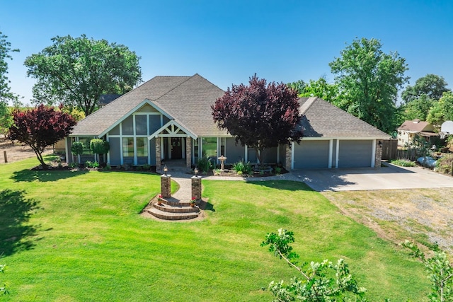 view of front of property featuring a garage and a front lawn