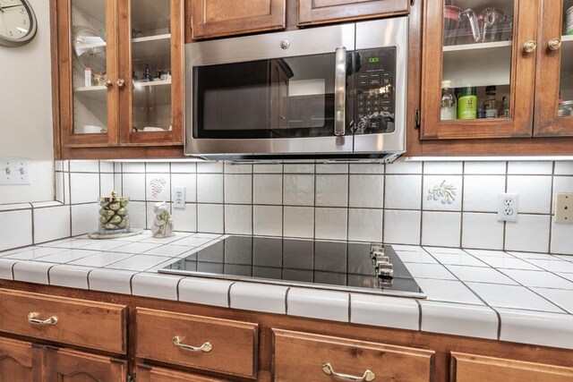 kitchen with black electric cooktop and backsplash