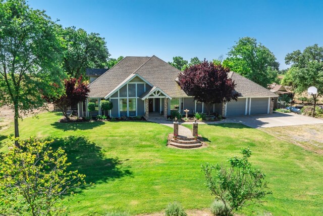 view of front of home with a garage and a front lawn