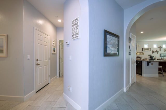 hall featuring light tile flooring