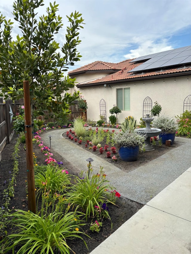 view of side of property featuring solar panels