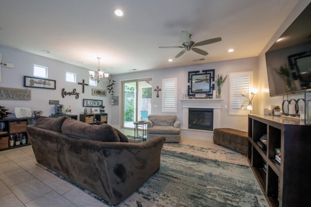 tiled living room featuring ceiling fan with notable chandelier