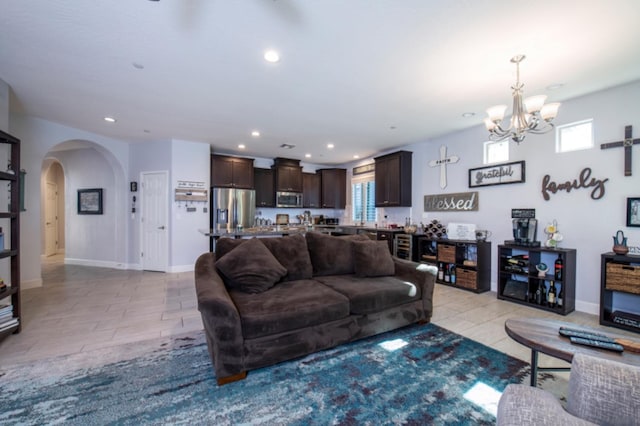 living room featuring an inviting chandelier and light tile floors