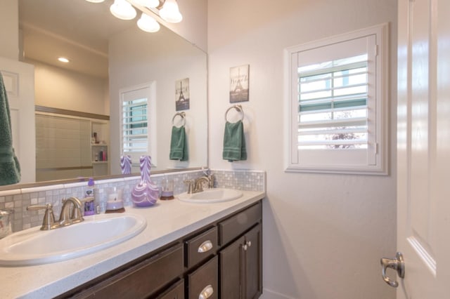 bathroom with backsplash and dual bowl vanity