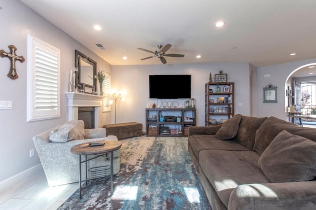 tiled living room with ceiling fan