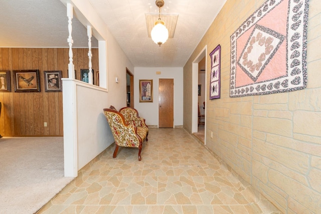 hall featuring wood walls