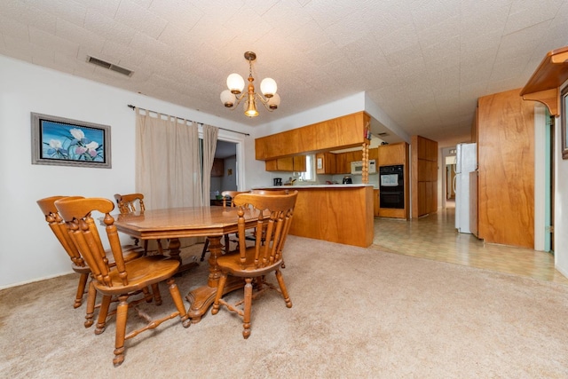 tiled dining room with an inviting chandelier