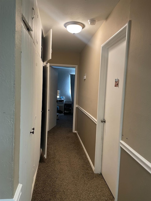 hallway with dark carpet