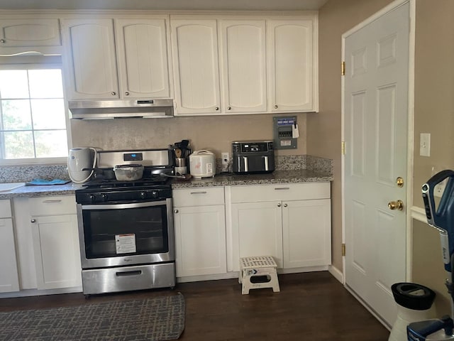 kitchen with dark hardwood / wood-style flooring, light stone counters, stainless steel range, and white cabinetry